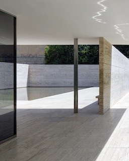 A partially-outdoor patio space with smooth marble and glass surfaces