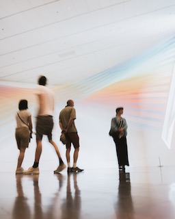 People looking at a colorful art installation