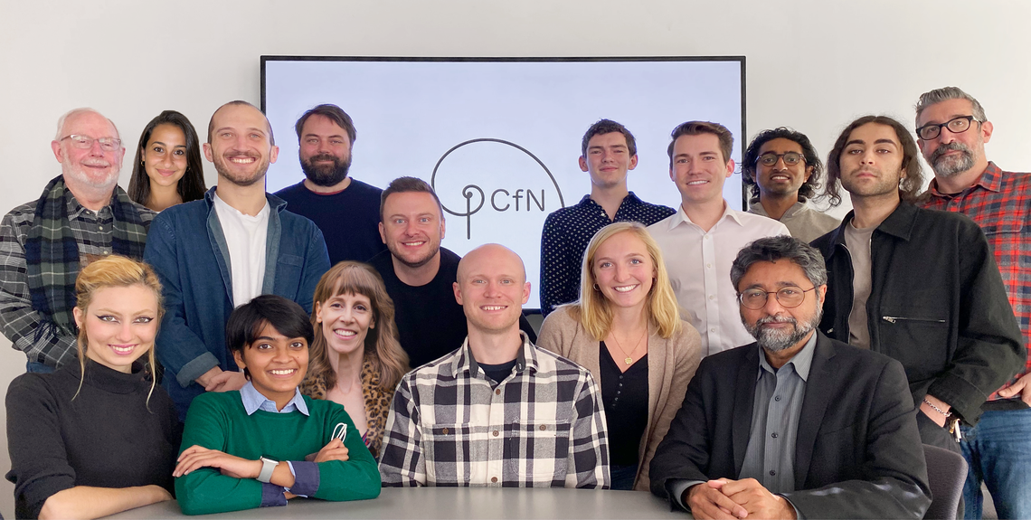 Lab group photo in front of PCfN logo